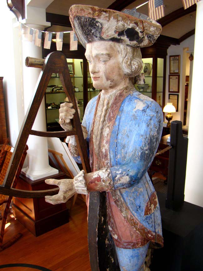 An exceptionally rare 18th century Ship Chandler's Trade Sign in the form of a French Naval Captain looking through his octant circa 1750.